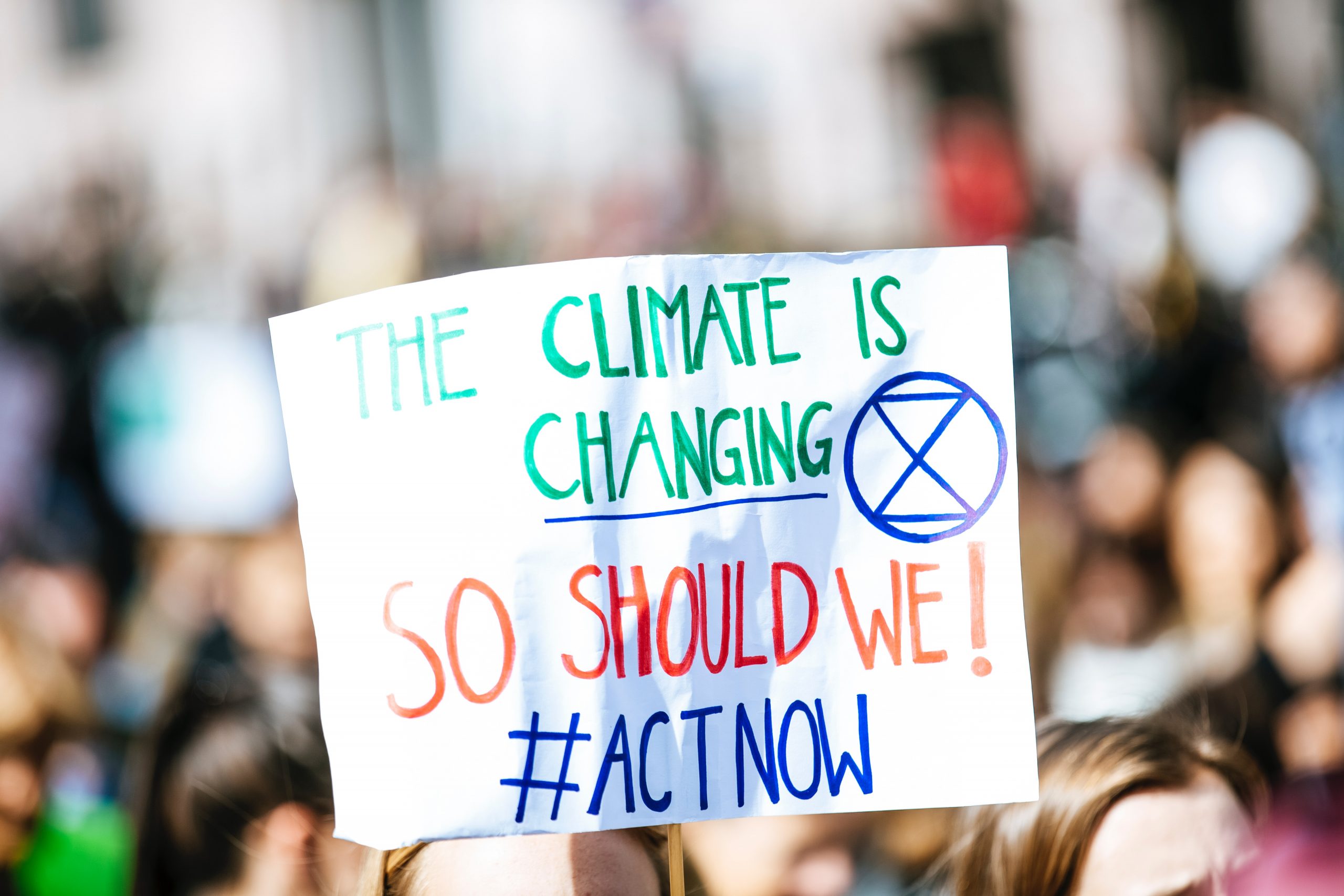 Placard reading 'the climate is change=ing, so should we'